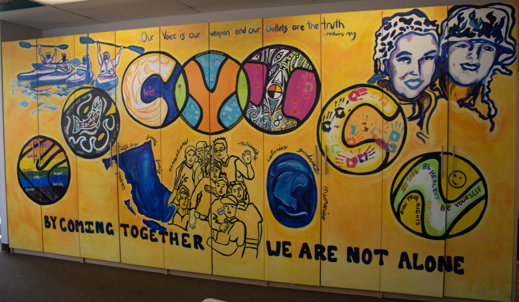 "By coming together we are not alone" mural