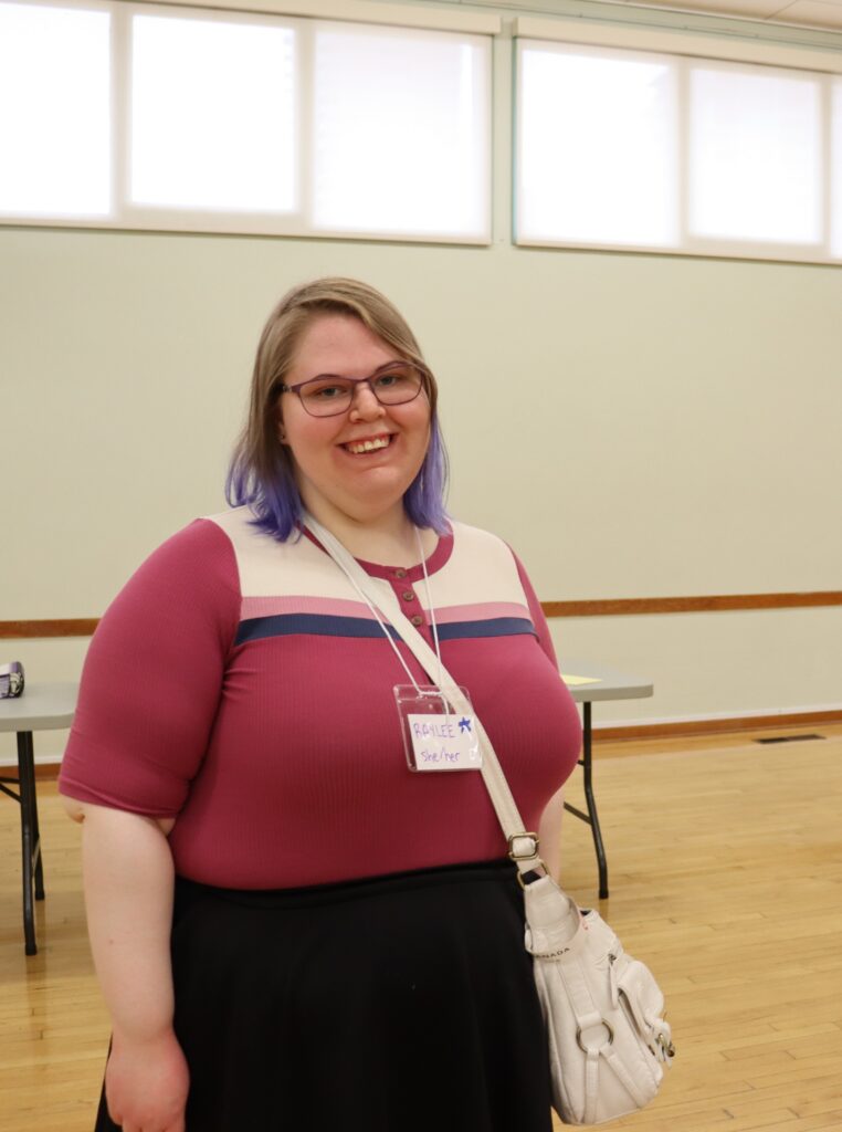 cheerful woman in community hall lavender hair