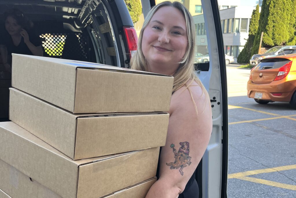 happy delivery person carrying boxes