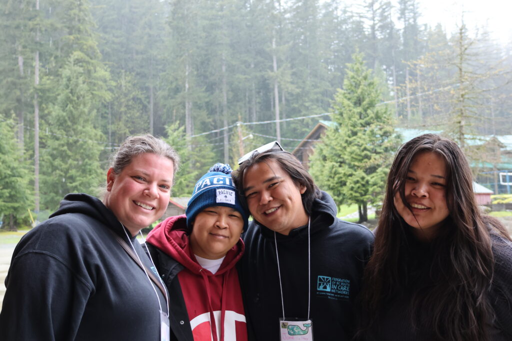Group of friends enjoying a scenic outdoor hike in lush forest setting.